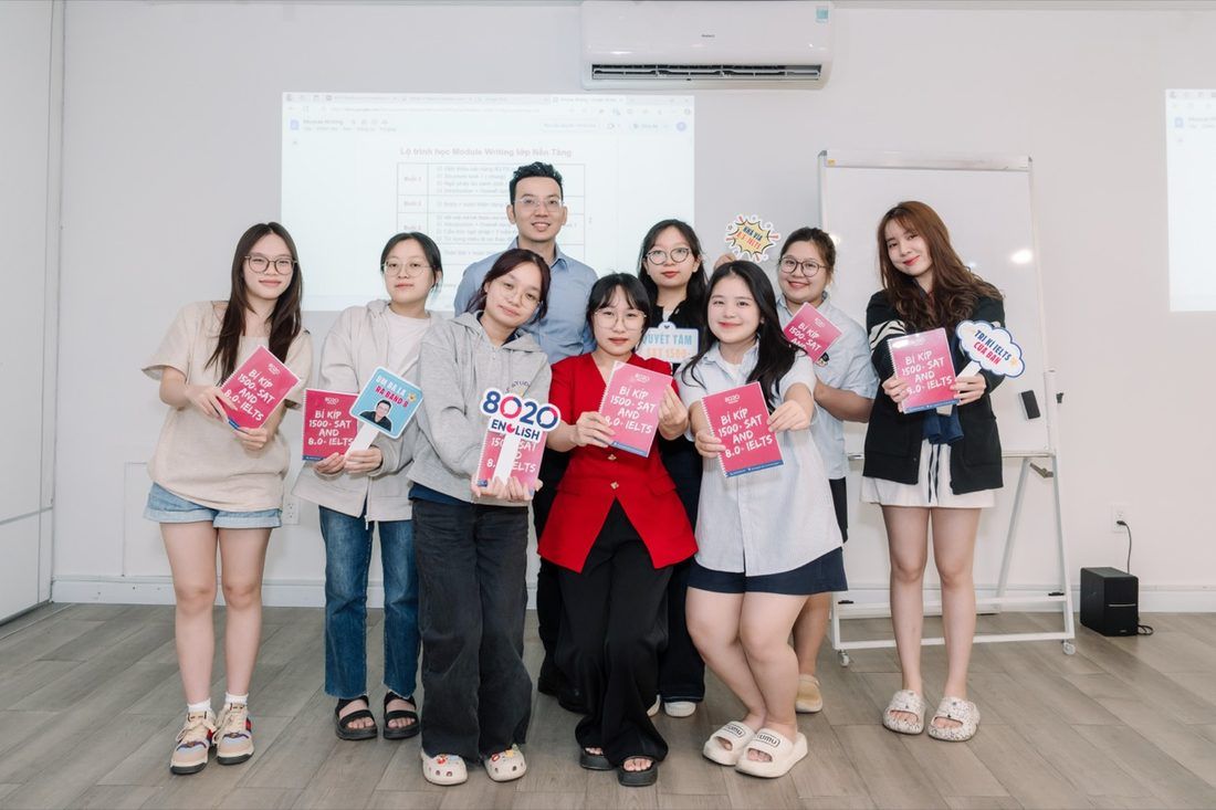 Students holding 8020 study handbooks after a class